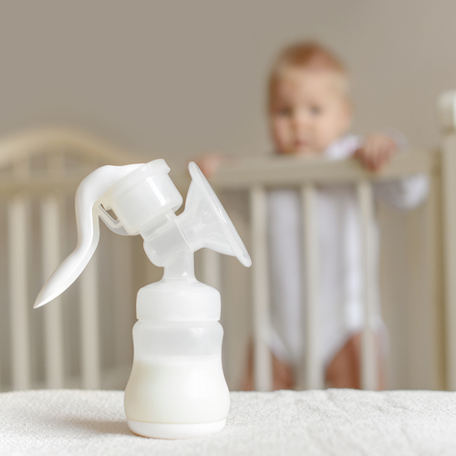 Manual,Breast,Pump,With,Breast,Milk,On,The,Background,Of